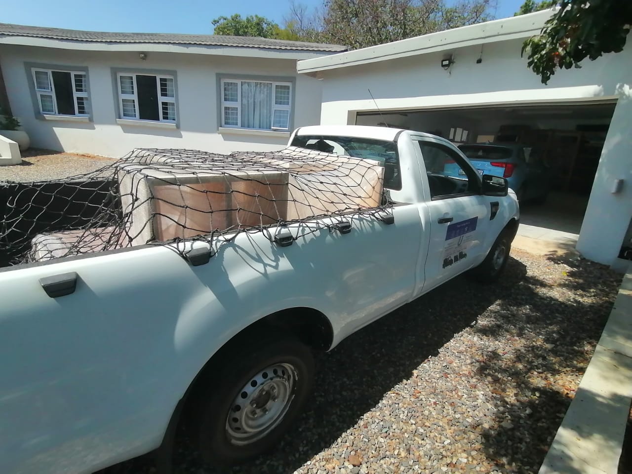 Bakkie loaded with secured cargo under cargo net